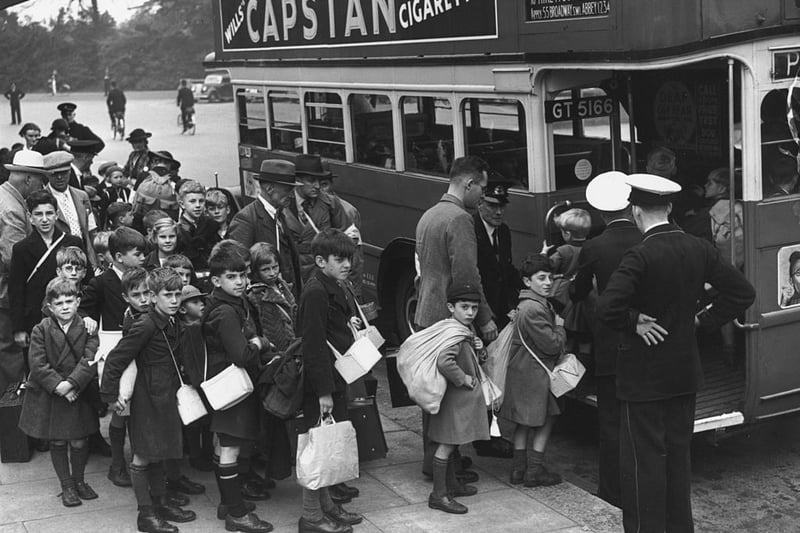 September 1 1939:  Evacuee children carrying their gas masks boarding a bus to leave London for the countryside a few days before Britain entered WWII.  (Photo by Fox Photos/Getty Images)