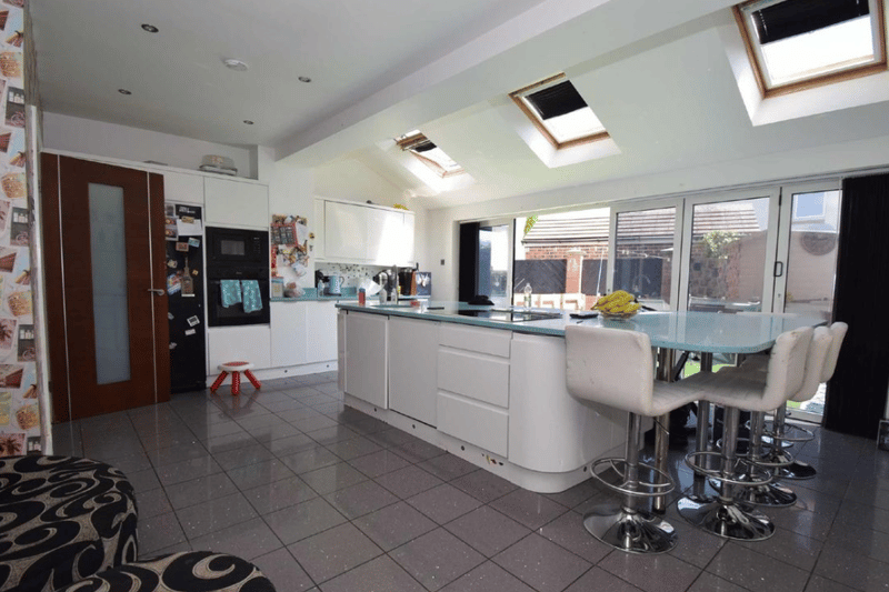 A first look at this stunning kitchen, which grants easy access to the garden and has a huge and modern worktop