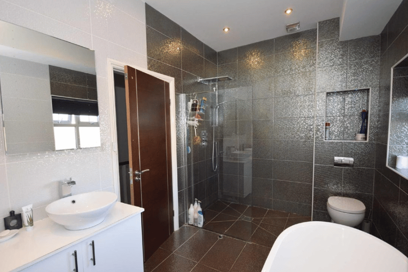 Another view of the bathroom showcasing a huge walk in shower