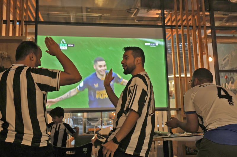 Saudi fans of English football club Newcastle United celebrate a goal scored against Tottenham during as they watch the match at a cafe, in Riyadh on October 23, 2022.