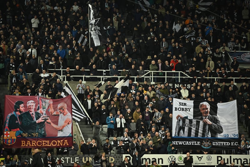 Newcastle United’s supporter wave flags picturing Newcastle United late English football player and manager Bobby Robson in tribute of  his 90th birthday during the English Premier League football match between Newcastle United and Liverpool at St James’ Park on February 18, 2023