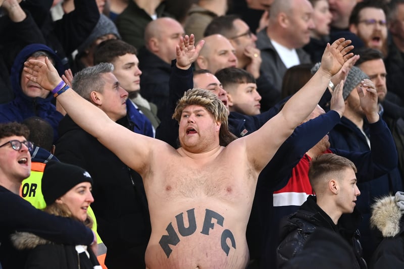 A  bare chested Newcastle fan with ‘NUFC’ tattooed on his stomach sings his heart out for the lads during the Premier League match between Leeds United  and  Newcastle United at Elland Road on January 22, 2022.