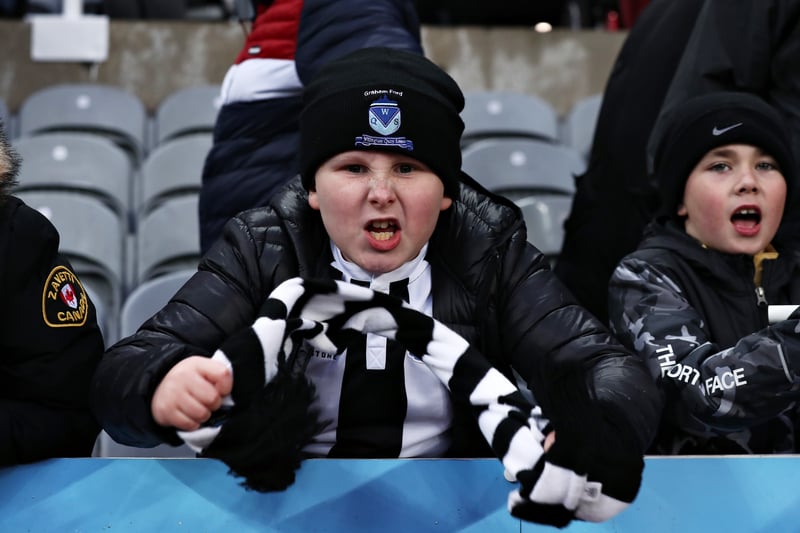 A young Newcastle United fan celebrates after the Premier League match between Newcastle United and Aston Villa at St. James Park on February 13, 2022