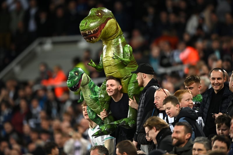 Fans of Newcastle United carry T-Rex inflatables to taunt Jordan Pickford of Everton during the Premier League match between Newcastle United and Everton FC at St. James Park on October 19, 2022