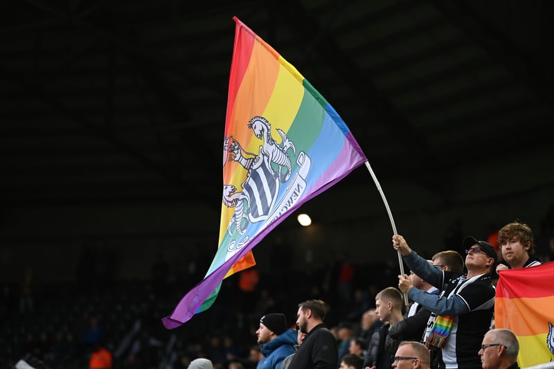 A rainbow laces flag is flown by Newcastle United fans in the Gallowgate End during the Premier League match between Newcastle United and Aston Villa at St. James Park on October 29, 2022.