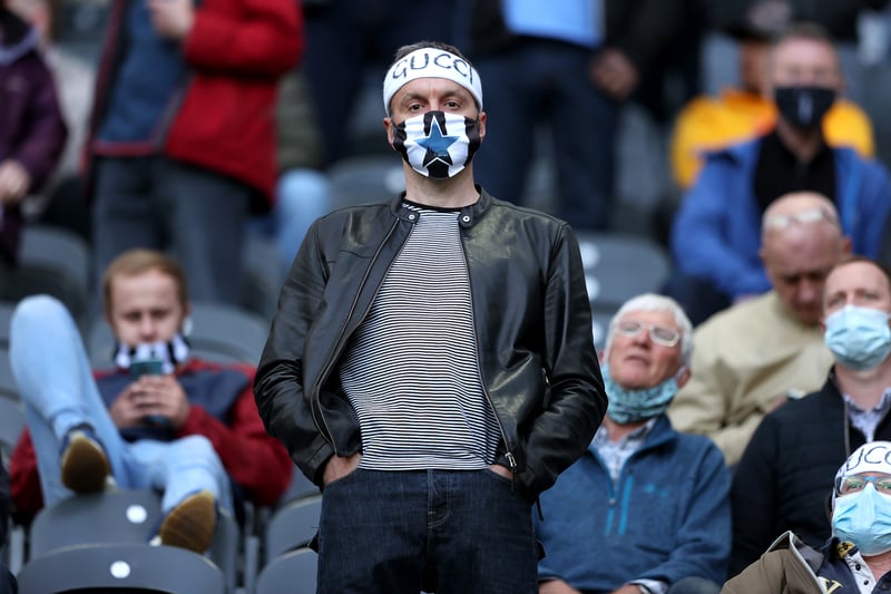 A Newcastle supporter wears a 'Gucci' head band in reference to player Allan Saint-Maximin during the Premier League match between Newcastle United and Sheffield United at St. James Park on May 19, 2021