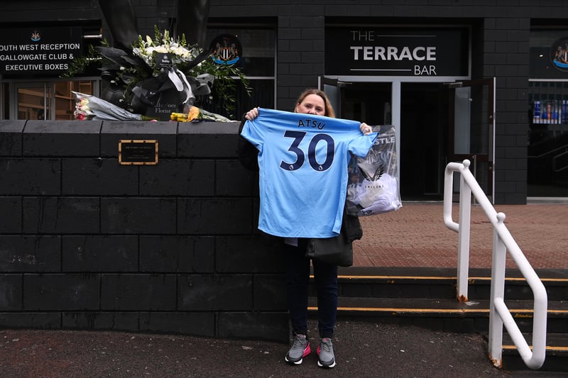A fan is seen with a shirt of former Premier League player Christian Atsu, who was recovered from the rubble of his home in Hatay following the Turkey earthquake tragedy.