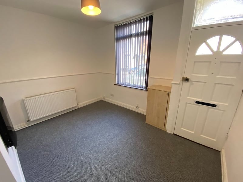 View of the front door and living room