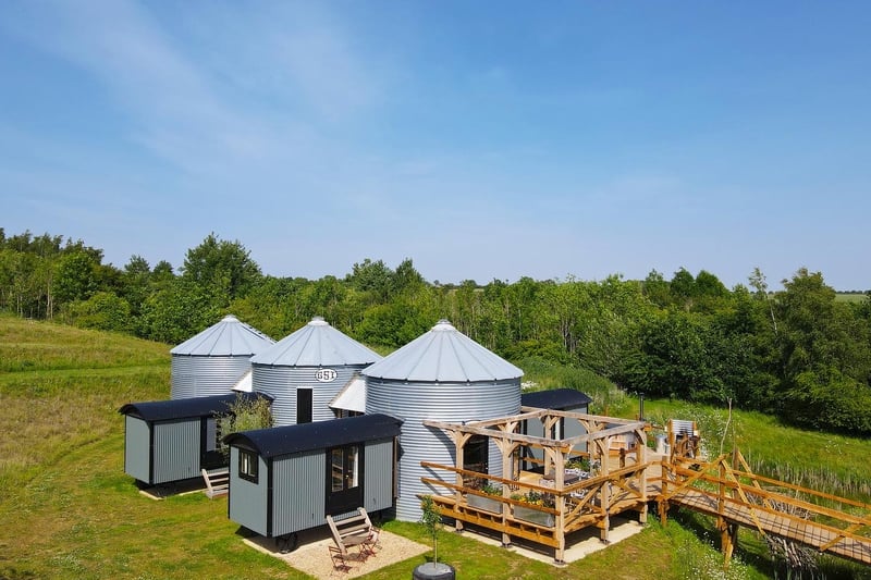 The Rocket lodge consists of 3 x reclaimed grain silos and 4 x shepherds huts all connected by oak framed glazed links.