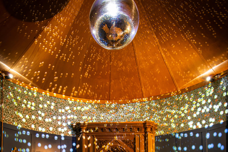 The one-of-a-kind bathing room comes with a disco ball overhead.