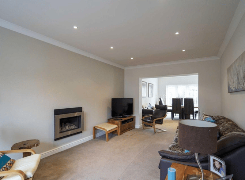 One of the sitting rooms located in the property, complete with a fire place. The TV could be wall-mounted to maximise space, with artwork and more added to the free space