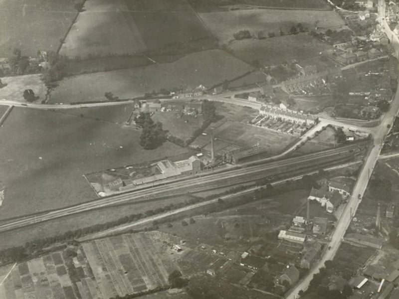 This aerial image shows a small section of Warmley Railway Station on the right hand side of the A420 London Road. The station, opened in 1869 and closed in 1966, now has a cafe popular with cyclists and walkers using the old Bath Green Park to Bristol railway line.