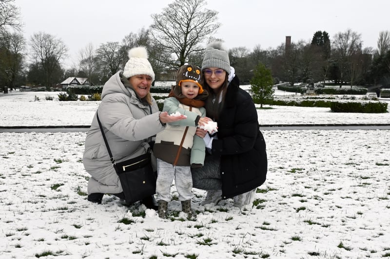 A winter scene in Mesnes Park, Wigan.  Charlie, three, has fun in the snow with nanny Khrista Coyle and mum Chloe Coyle, right. Credit:  Michelle Adamson