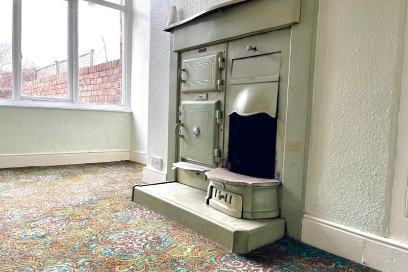 This room features an antique cooking range fireplace.