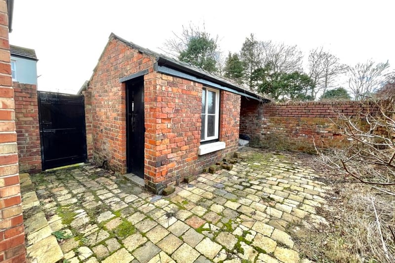 The property has a large garage, outbuilding and ample parking.