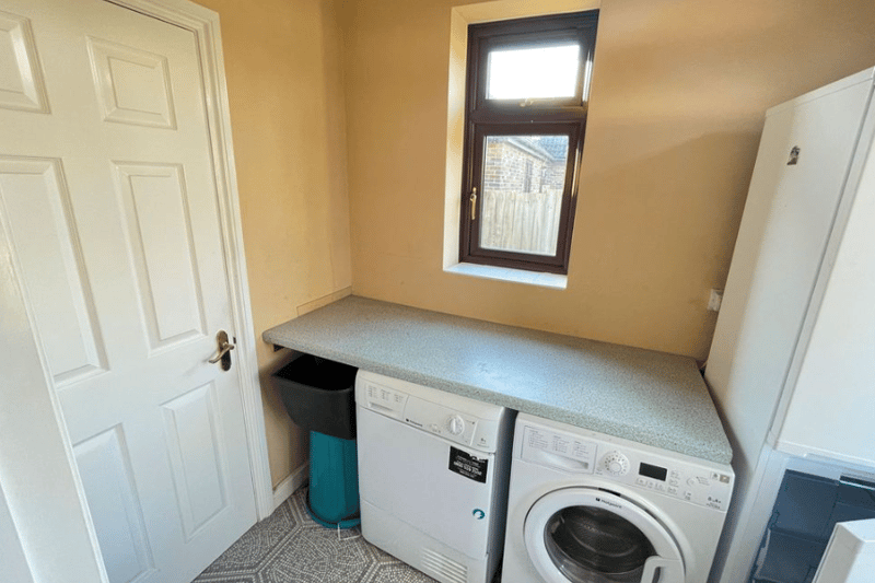 A small corner dedicated to the bin and washing machine, allowing for more space in the main area of the kitchen
