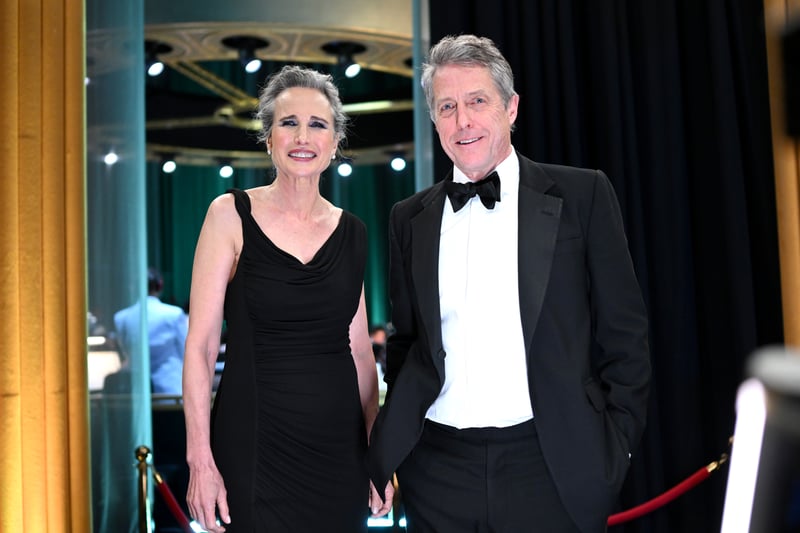 Andie MacDowell and Hugh Grant. MacDowell wore a fitted black dress while Grant wore a smart tuxedo.