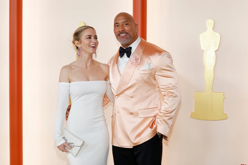 Emily Blunt and and Dwayne Johnson. Blunt wore a figure-hugging white Valentino dress with long sleeves and Johnson wore a pastel coloured Dolce and Gabbana suit.