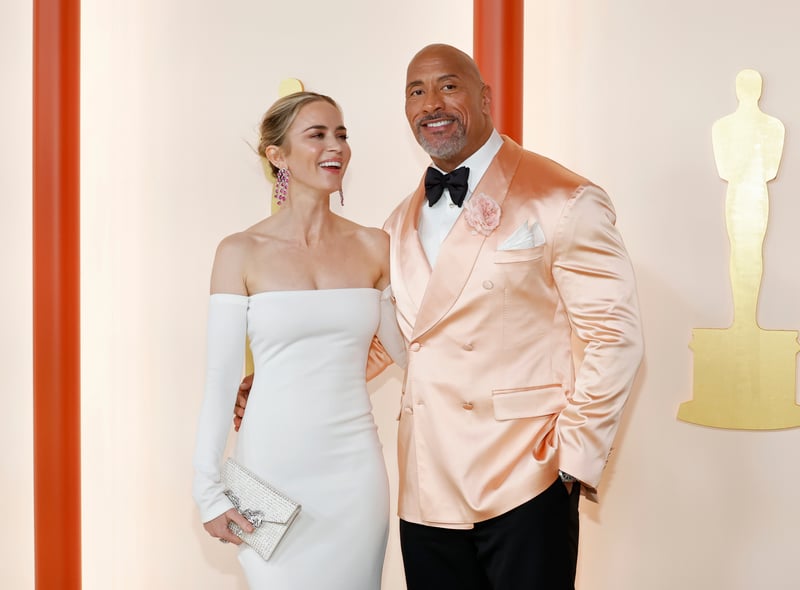 Emily Blunt and and Dwayne Johnson. Blunt wore a figure-hugging white Valentino dress with long sleeves and Johnson wore a pastel coloured Dolce and Gabbana suit.