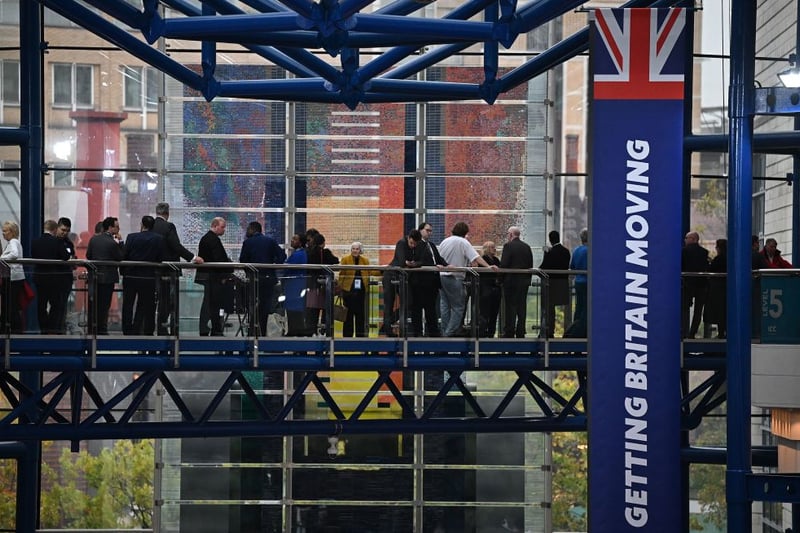 Delegates queue to enter the main conference hall ahead of the main speeches  on the final day of the annual Conservative Party Conference in Birmingham, central England, on October 5, 2022. (Photo by Oli SCARFF / AFP) (Photo by OLI SCARFF/AFP via Getty Images)