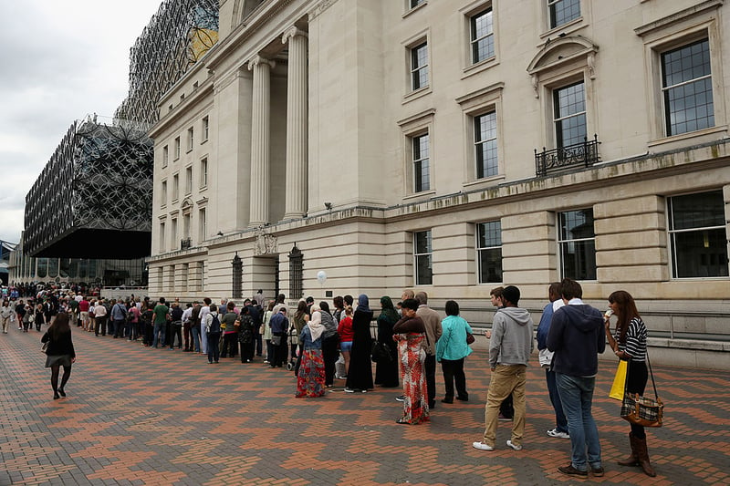 Members of the public queue to view the new Library of Birmingham at Centenary Square after it’s official opening on September 3, 2013 in Birmingham, England. The new futuristic building was officially opened by 16-year-old Malala Yousafzai who was attacked by Taliban gunmen on her school bus near her former home in Pakistan in October 2012. The new building  was designed by architect Francine Hoube and has cost 189 million GBP. The modern exterior of interlacing rings reflects the canals and tunnels of Birmingham. The library’s ten floors will house the city’s internationally important collections of archives, photography and rare books as well as it’s lending library.  (Photo by Christopher Furlong/Getty Images)