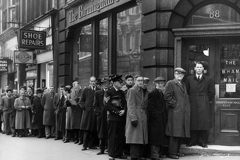 31st March 1955:  People queuing to buy a newspaper outside the offices of the Birmingham Post in Fleet Street, London, where no national papers are being printed due to a strike.  (Photo by George W. Hales/Fox Photos/Getty Images)