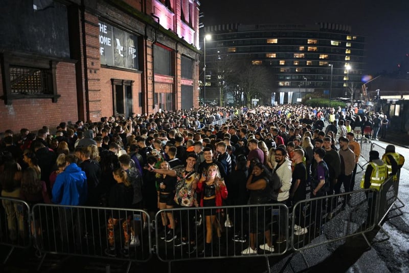 Party-goers queue outside Depot Mayfield for the New Year’s Eve celebrations in 2021.  (Photo by OLI SCARFF/AFP via Getty Images)