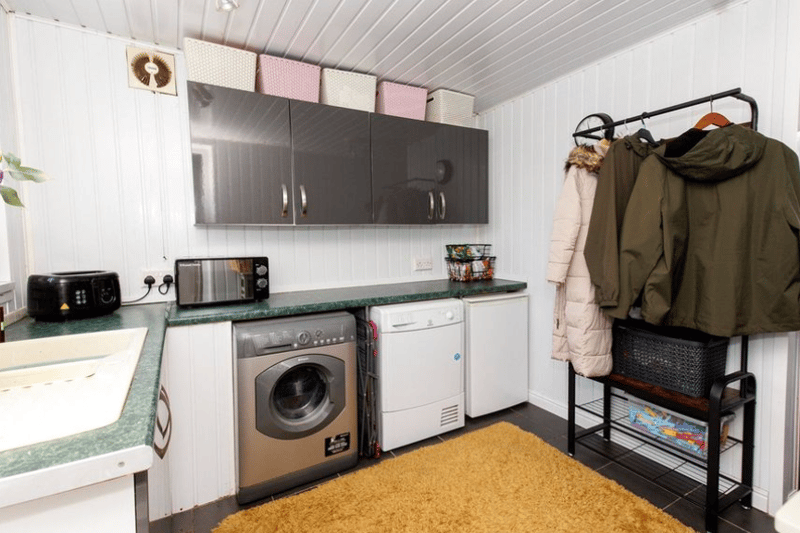 A utility room is pictured here, freeing up space elsewhere