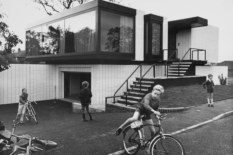 Children playing on bicycles outside the new home of footballer George Best on Blossoms Lane in Bramhall. Credit: Getty