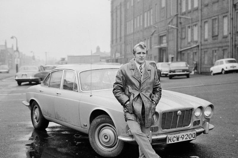 Footballer Francis Lee of Manchester City FC leaning on the front of a car. Credit: Getty