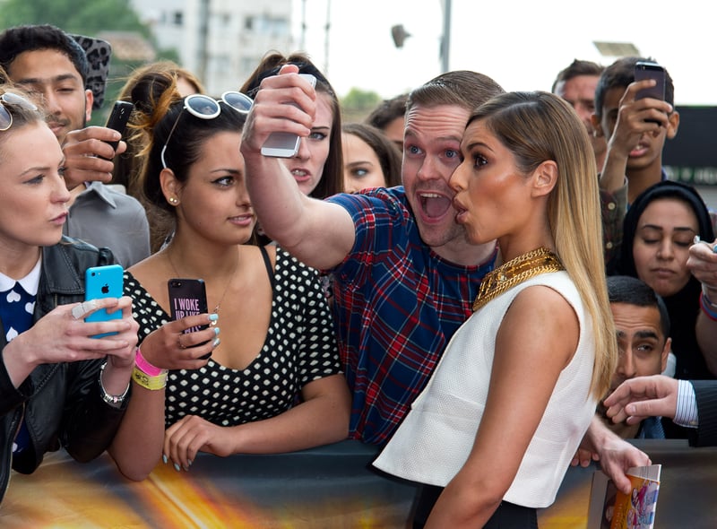 In 2014, Cheryl posed for a photo with a fan at the London Auditons.