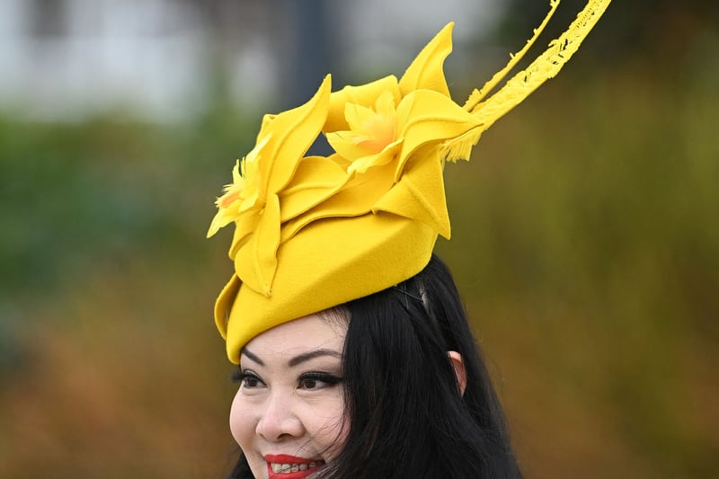 A racegoer poses as she arrives on the second day of the Cheltenham 