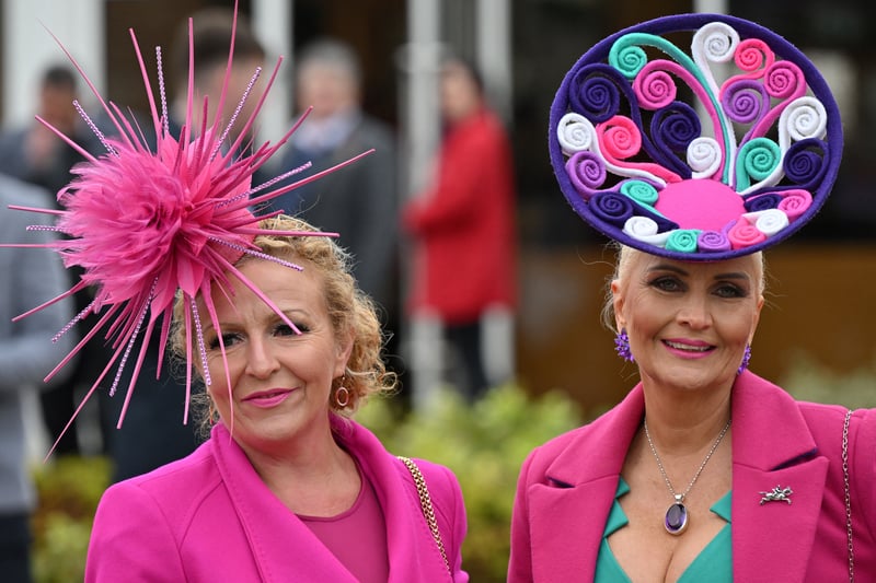 Racegoers pose upon their arrival on the second day of the Cheltenham Festival at Cheltenham Racecourse
