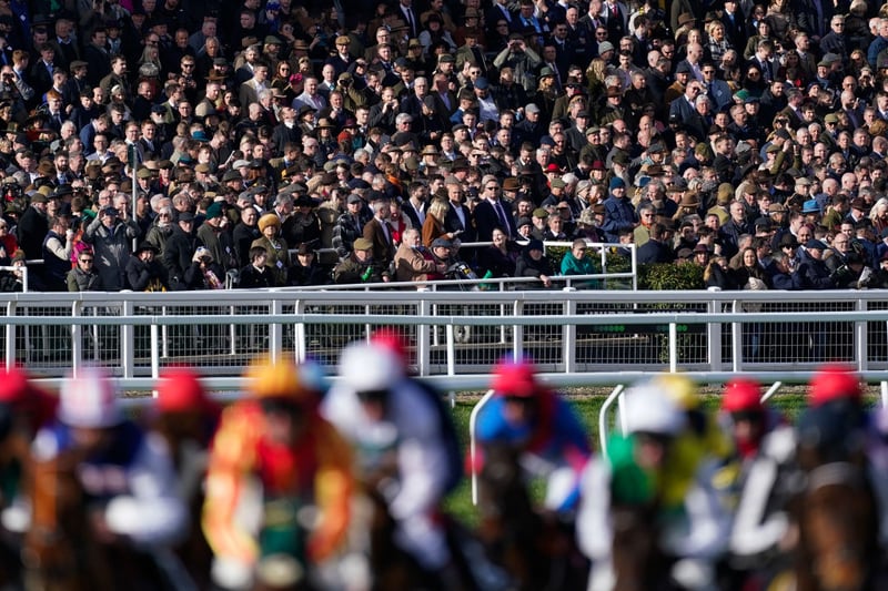 Racegoers keep an eye on the action during The Ultima Handicap Chase during day one of the Cheltenham Festival 2023 at Cheltenham Racecourse on March 14, 2023 in Cheltenham, England. (Photo by Alan Crowhurst/Getty Images)