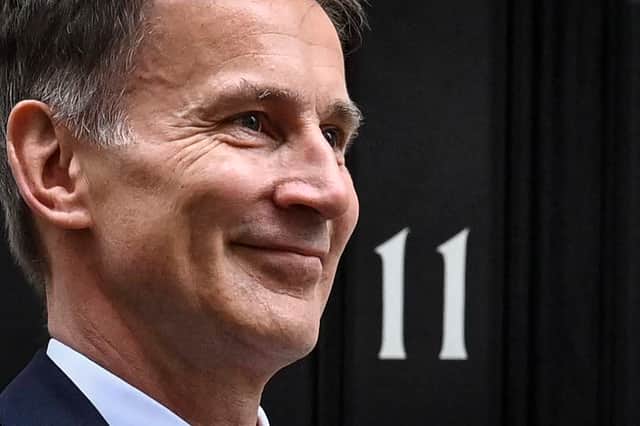 Britain’s Chancellor of the Exchequer Jeremy Hunt poses as he leaves 11 Downing Street in central London on March 15, 2023, to present the government’s annual budget to Parliament. (Photo by JUSTIN TALLIS / AFP) (Photo by JUSTIN TALLIS/AFP via Getty Images)