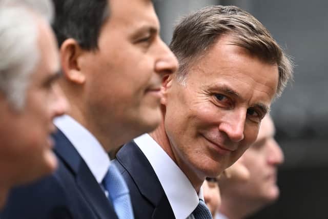 Britain's Chancellor of the Exchequer Jeremy Hunt poses as he leaves 11 Downing Street in central London on March 15, 2023, to present the government's annual budget to Parliament. (Photo by JUSTIN TALLIS / AFP) (Photo by JUSTIN TALLIS/AFP via Getty Images)