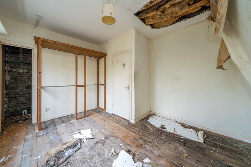 Bedroom with damaged ceiling