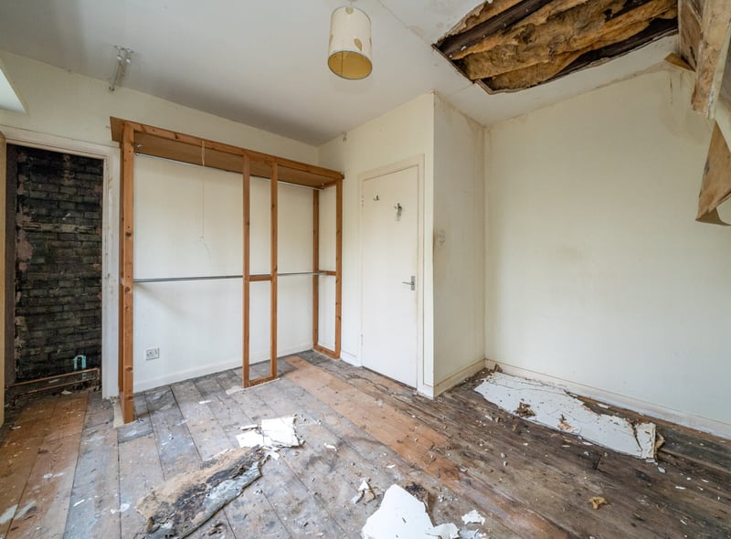 Bedroom with damaged ceiling