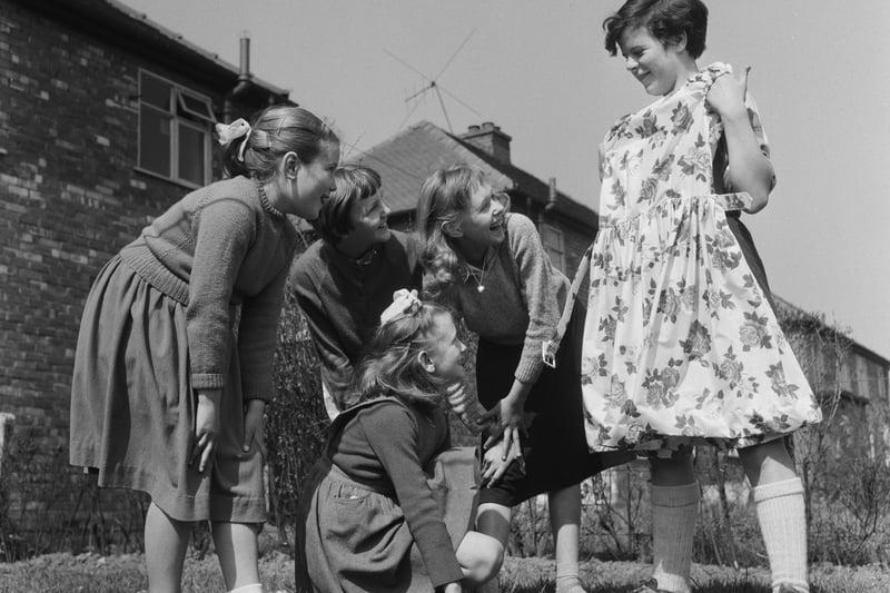 Margaret Wilde (right) shows off a new dress to her friends (left to right) Norma Boardman (9), Jean Brook (9), Joan Barnett (10) and Brenda Brook (12) near her home in  Denton Credit: Getty