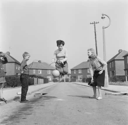 12 year-old footballer Margaret Wilde bounces and catches a football while skipping, as part of her training regime with Nomad Ladies,  near her home in Denton. Credit: Getty