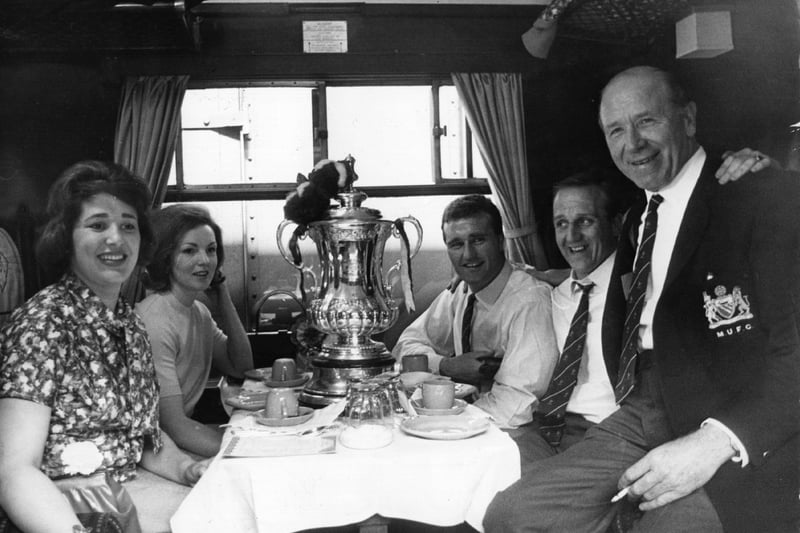 Travelling in style! embers of the Manchester United team in their train carriage before leaving London for Manchester, after their 3-1 victory over Leicester City in the FA Cup Final, with boss Matt Busby.