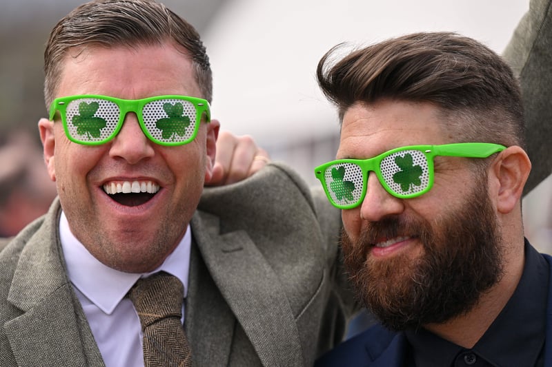 Racegoers wearing shamrock-themed sunglasses arrive to attend the final day
