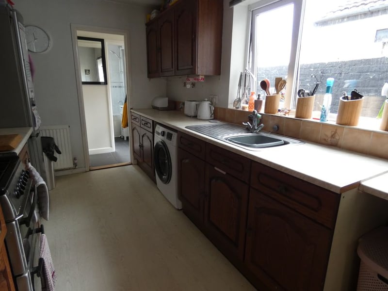 Kitchen with space for a washing machine and fridge/freezer