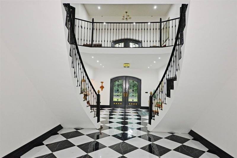 The double curved stairs and marbled floor brings a palatial feel.