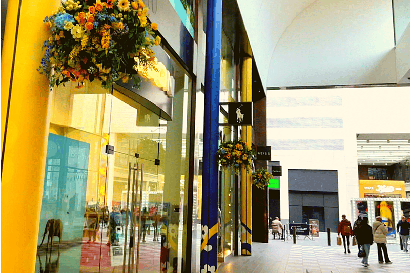 Shops on Peter’s Lane have received a blue and yellow makeover, as well featuring hanging Spring flowers!