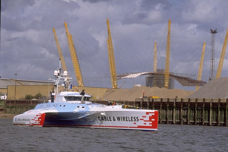In 1998 the  Cable and Wireless Adventurer passes by the under-construction Millenium Dome during her christening on the River Thames. (Photo by Graham Chadwick /Allsport/Getty)
