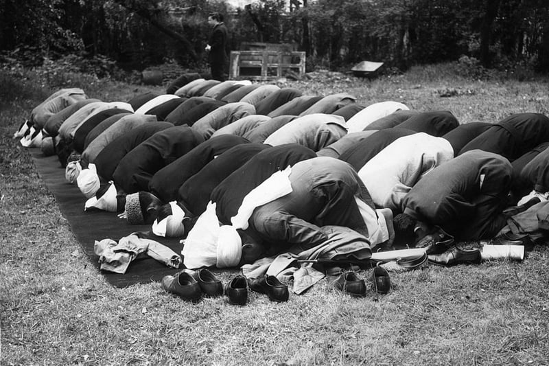 May 12 1956: Worshippers at the London Mosque kneel in obeisance minus their shoes during the festival Eid al-Fitr.
