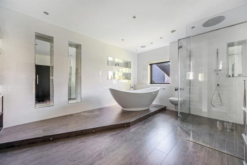 Large bathroom with shower and bathtub.