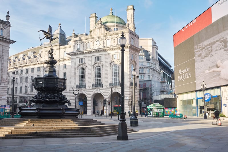 The statue of Eros stands alone in the empty streets of Piccadilly Circus.