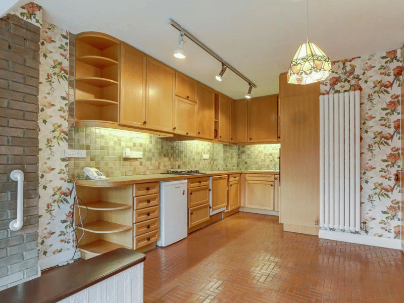 A broader look of the kitchen, with great storage space